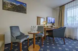 Hotel room with a small table and desk